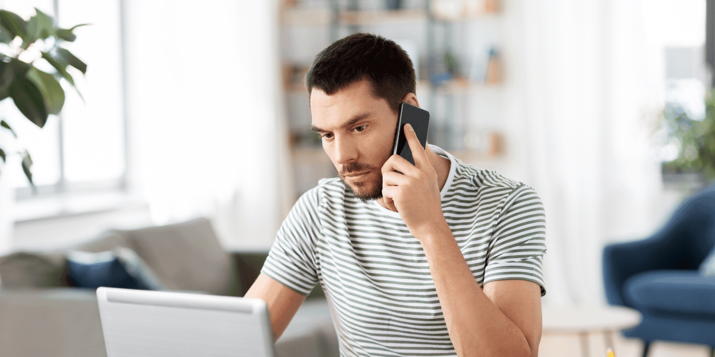 Ghosting from your gay partner is stressful as shown by this photograph of a man holding a phone looking heartbroken.