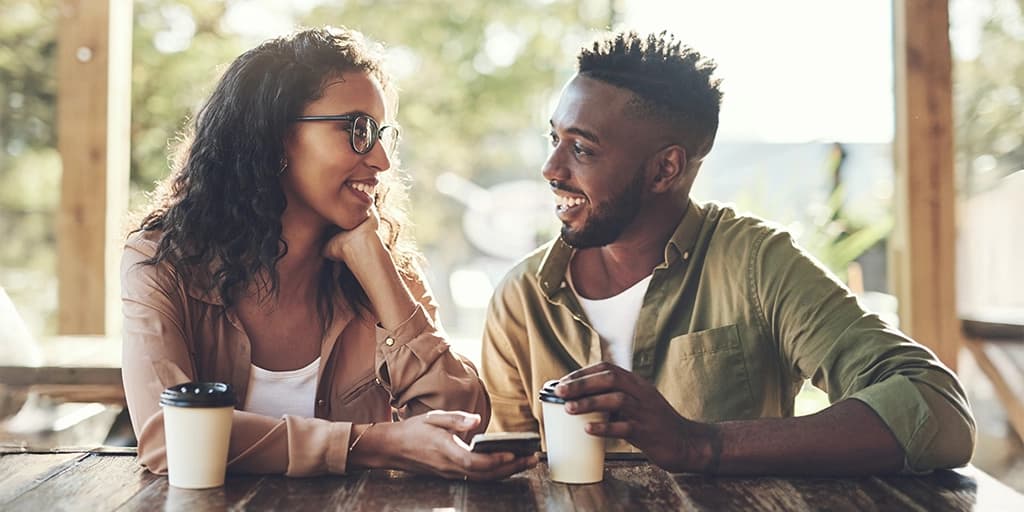 Do matchmaking services really work? An African American couple chat over coffee after meeting through Tawkify.