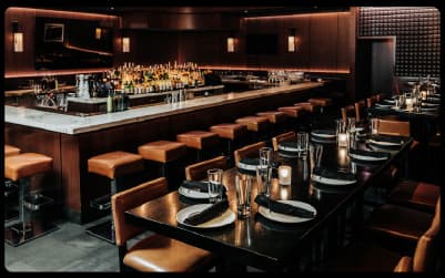 Leather bar seating and set tables inside RPM Steak in River North, Chicago