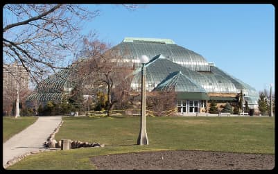 Glass domes of the Lincoln Park Conservatory in Chicago seen from the surrounding park