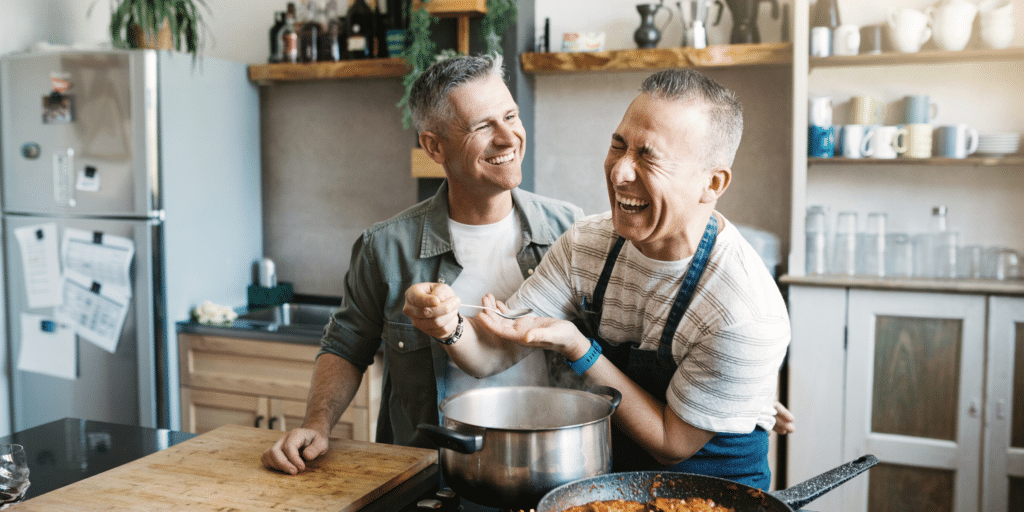 Two men cooking and laughing.